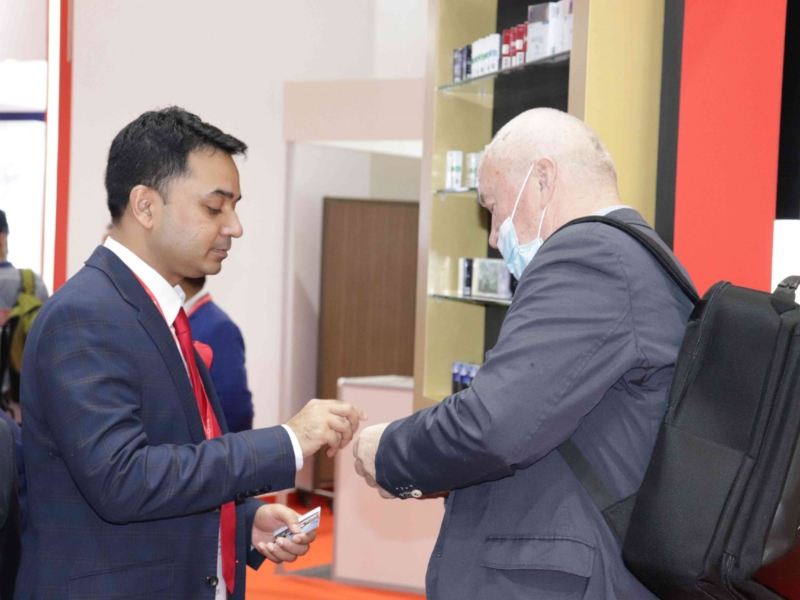 Welcoming a visitor to the Civic Tobacco Machinery stand